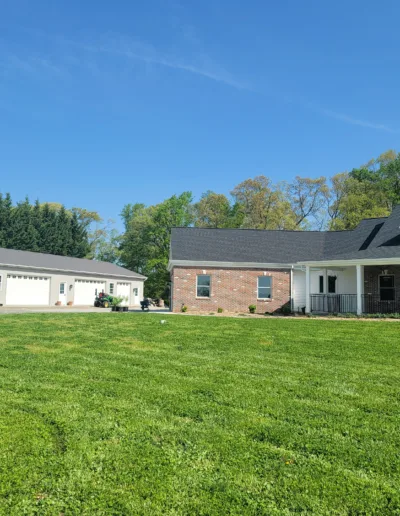 A house with a large yard and a garage.