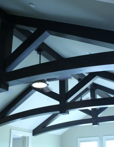 A room with wooden beams and a ceiling fan.