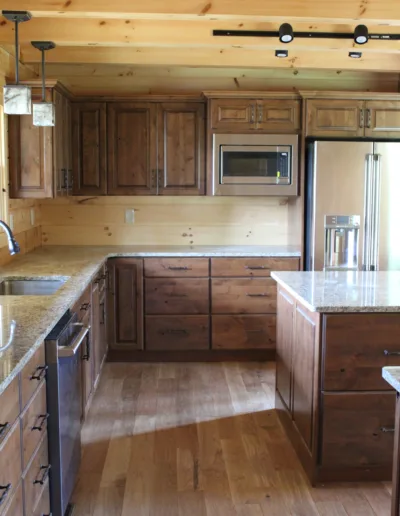A kitchen with wood cabinets and granite counter tops.