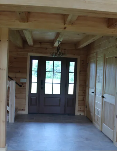 A wooden staircase in a log home.