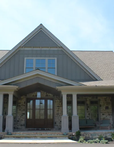 The front of a home with a stone front porch.