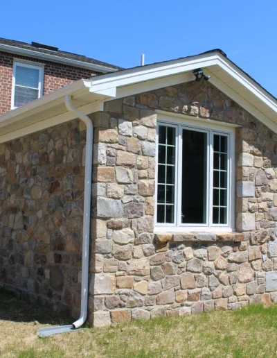 A stone wall with a window.