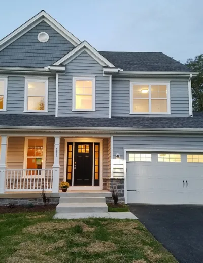 A home with two garages and a front porch.
